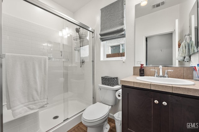 full bathroom with visible vents, vanity, toilet, and a shower stall