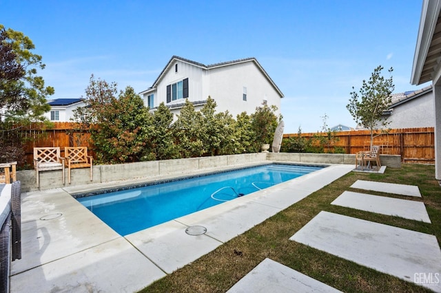 view of pool featuring a patio area, a fenced in pool, and a fenced backyard