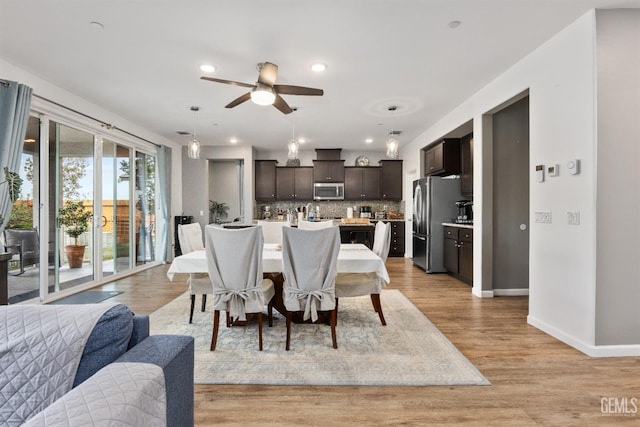 dining room featuring light wood finished floors, recessed lighting, a ceiling fan, and baseboards