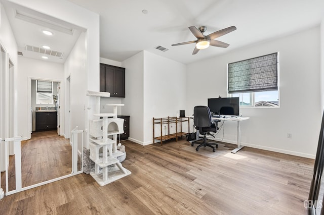 office featuring light wood-style floors, visible vents, and baseboards