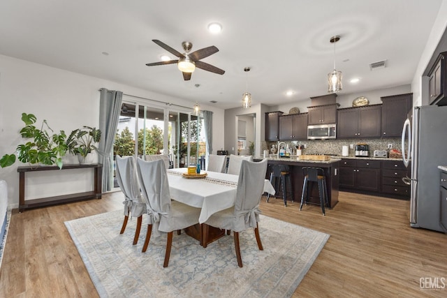 dining space with recessed lighting, visible vents, light wood-style flooring, and a ceiling fan