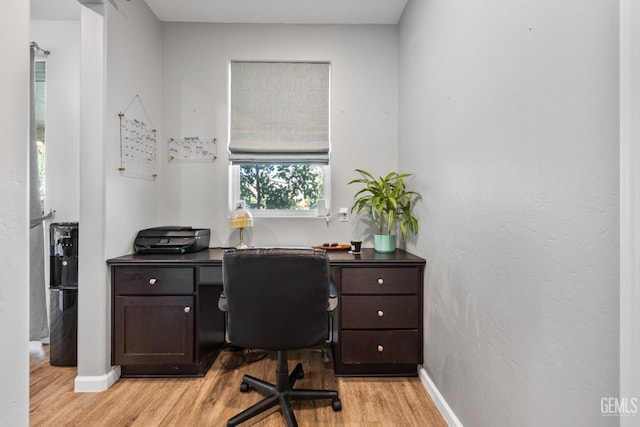 office space featuring light wood-style floors and baseboards