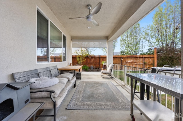 view of patio featuring outdoor dining area, a ceiling fan, outdoor lounge area, and fence