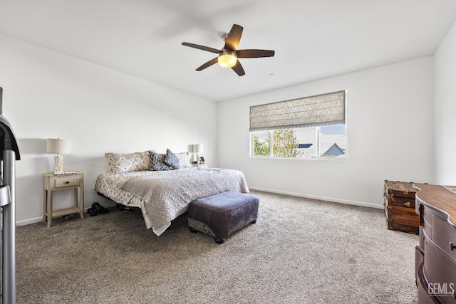 carpeted bedroom with a ceiling fan and baseboards