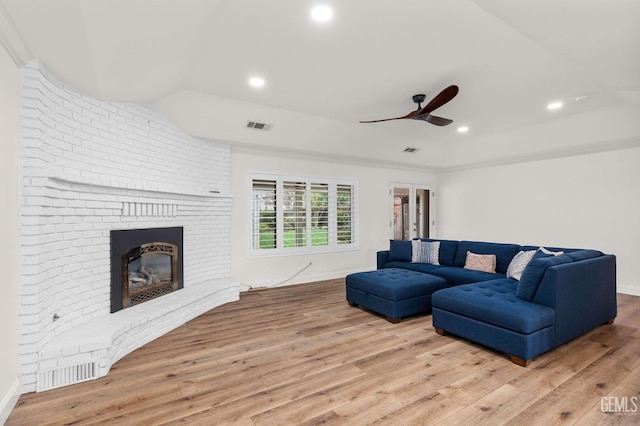 living room with visible vents, a ceiling fan, hardwood / wood-style floors, a brick fireplace, and recessed lighting