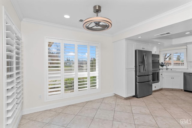 kitchen featuring light tile patterned floors, visible vents, appliances with stainless steel finishes, crown molding, and white cabinetry