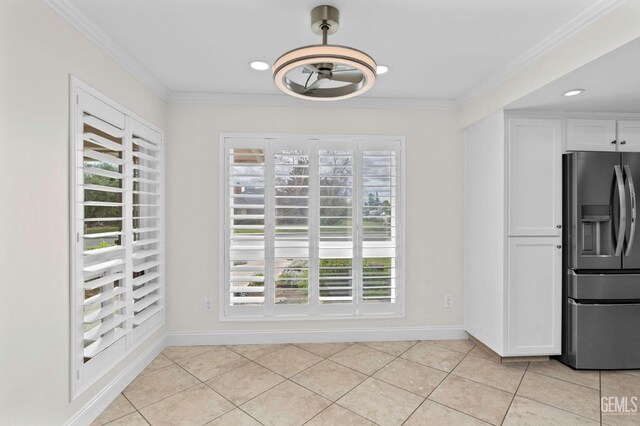 tiled dining room with sink and ornamental molding