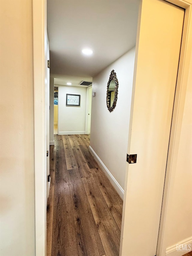 corridor with hardwood / wood-style flooring