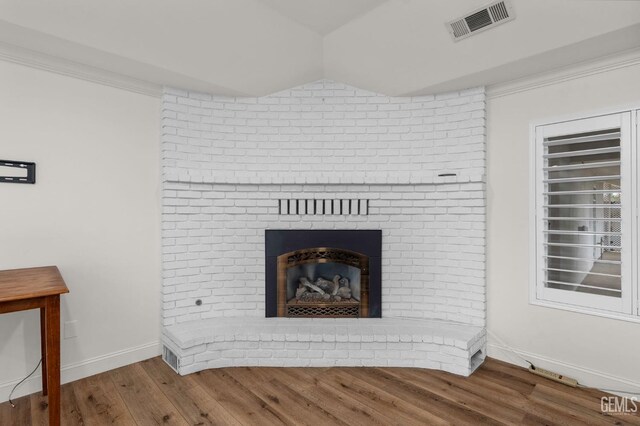 living room featuring a fireplace, hardwood / wood-style flooring, ceiling fan, and ornamental molding