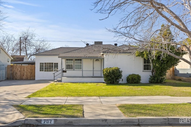 ranch-style home with a front lawn