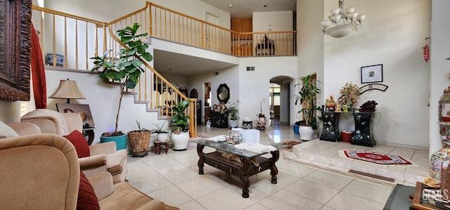 2013 Calle, Los Camichines, Bakersfield, CA 93309 - living area featuring arched walkways, light tile patterned floors, stairs, a chandelier, and a towering ceiling