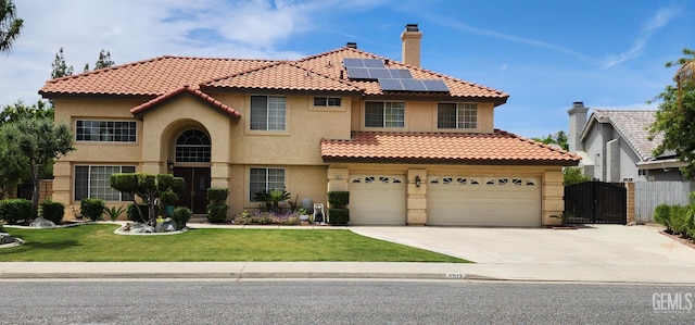 2013 Calle, Los Camichines, Bakersfield, CA 93309 - view of front of house featuring a gate, stucco siding, solar panels, driveway, and a tiled roof