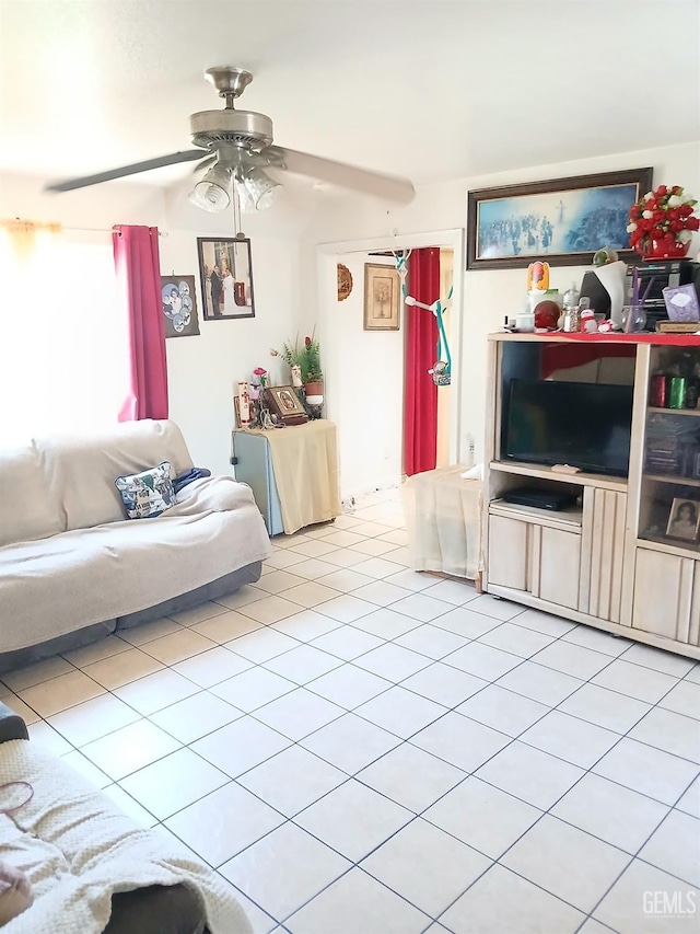 tiled living room with ceiling fan