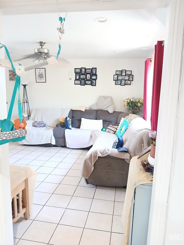 living room with ceiling fan and light tile patterned flooring