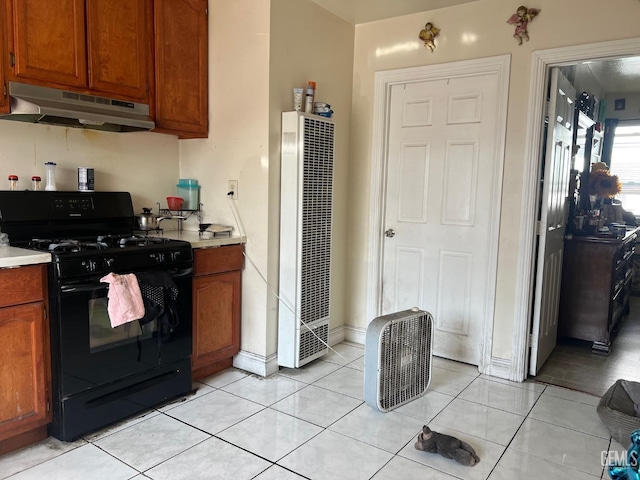 kitchen with black range with gas cooktop and light tile patterned floors