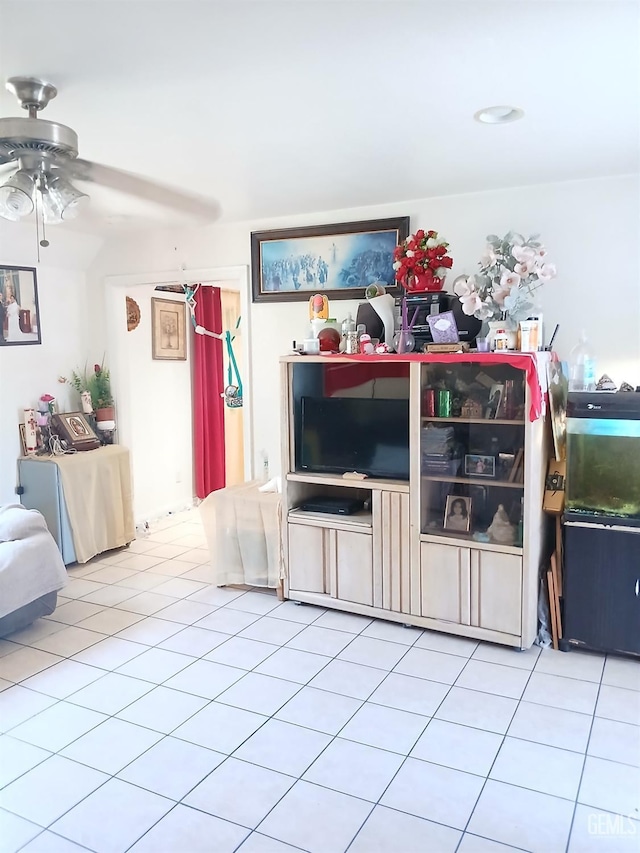 unfurnished living room featuring ceiling fan and light tile patterned floors