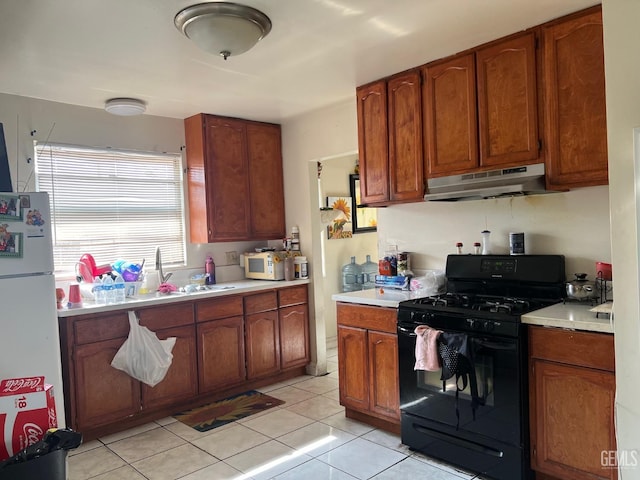 kitchen with light tile patterned floors, white appliances, and sink