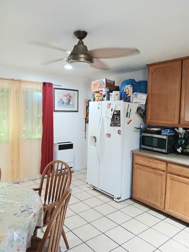 kitchen with white refrigerator with ice dispenser, light tile patterned floors, and ceiling fan