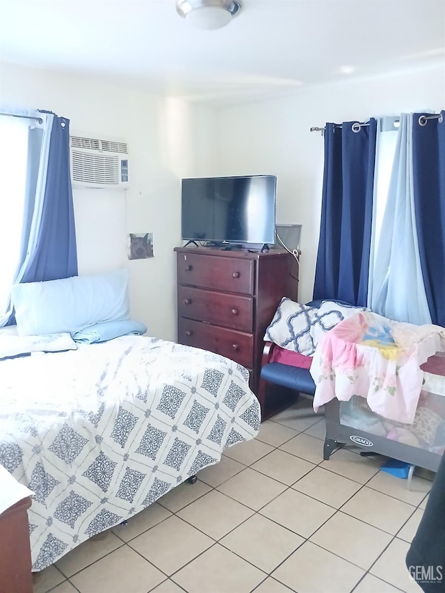 bedroom featuring a wall mounted air conditioner and light tile patterned floors