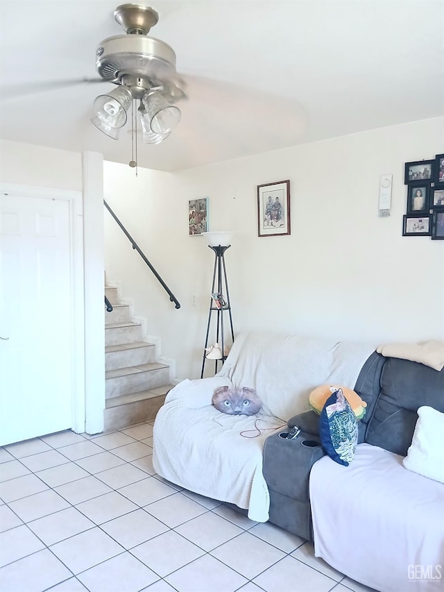 tiled living room featuring ceiling fan