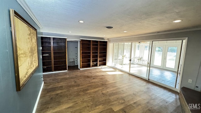 unfurnished room with french doors, ornamental molding, dark hardwood / wood-style floors, and a textured ceiling