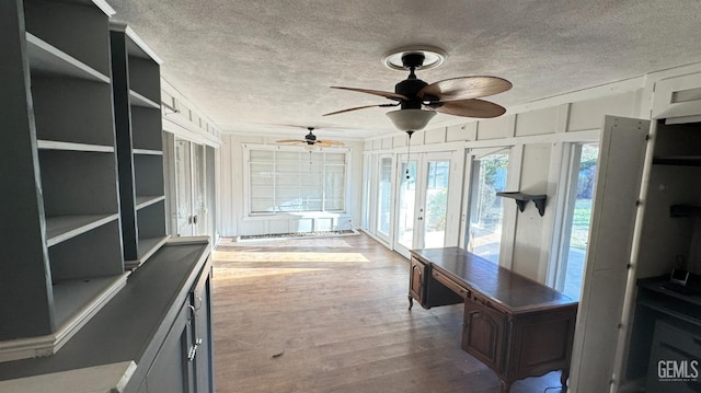 interior space featuring french doors and ceiling fan