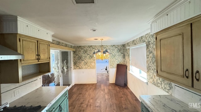 kitchen featuring pendant lighting, wall chimney range hood, crown molding, a notable chandelier, and dark hardwood / wood-style flooring