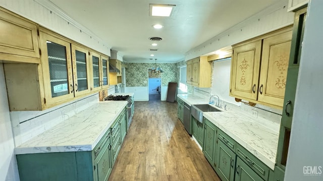 kitchen featuring sink, ornamental molding, dark hardwood / wood-style floors, stainless steel stove, and wall chimney range hood