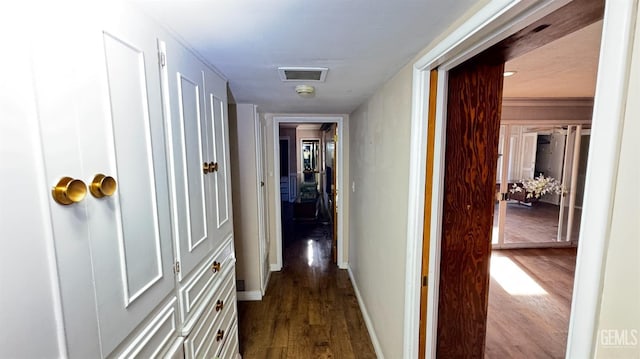 hallway featuring wood-type flooring and crown molding