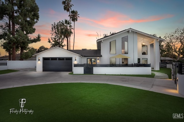 view of front of property featuring a garage and a yard