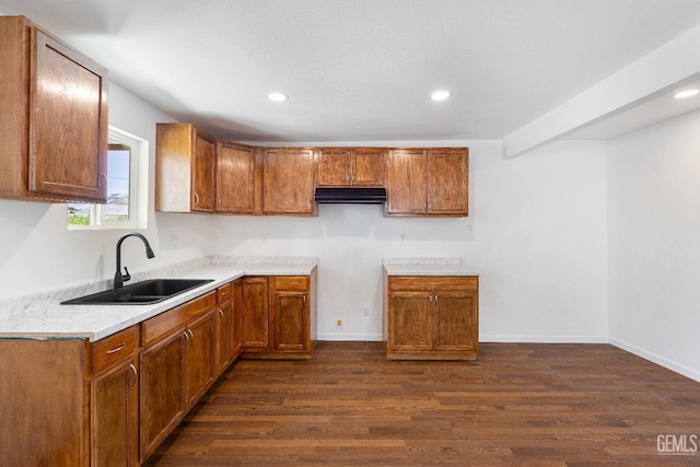 438 Cedar Ave, Earlimart, CA 93219 - kitchen with a sink, brown cabinetry, dark wood-type flooring, recessed lighting, and light countertops