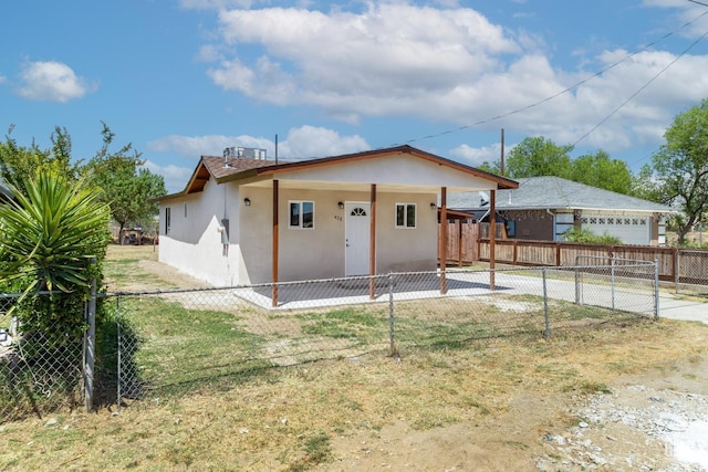 438 Cedar Ave, Earlimart, CA 93219 - rear view of property featuring stucco siding, fence, and concrete driveway