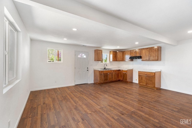 438 Cedar Ave, Earlimart, CA 93219 - kitchen with brown cabinetry, a sink, dark wood finished floors, baseboards, and recessed lighting