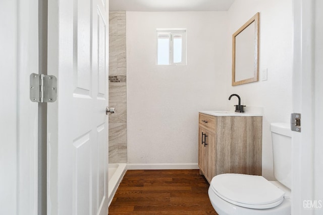 438 Cedar Ave, Earlimart, CA 93219 - bathroom with toilet, vanity, wood finished floors, baseboards, and a shower