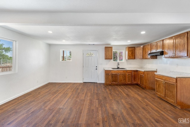 438 Cedar Ave, Earlimart, CA 93219 - kitchen featuring a sink, under cabinet range hood, brown cabinets, dark wood-style flooring, and recessed lighting