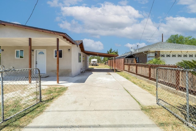 438 Cedar Ave, Earlimart, CA 93219 - view of side of property featuring fence, an attached carport, and stucco siding