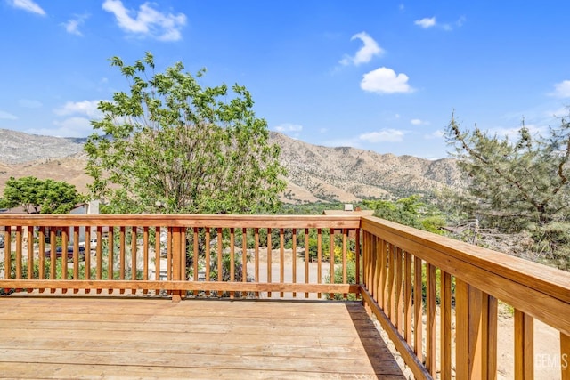 wooden deck with a mountain view