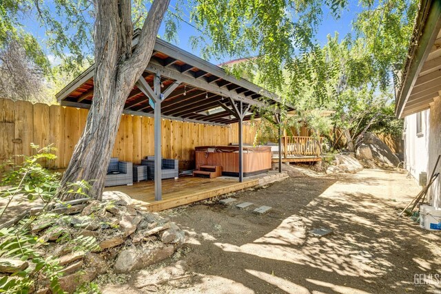 view of patio / terrace with a wooden deck and a hot tub