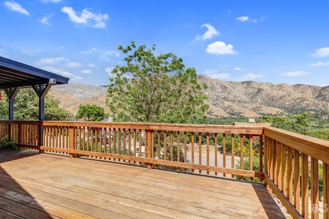 wooden deck with a mountain view