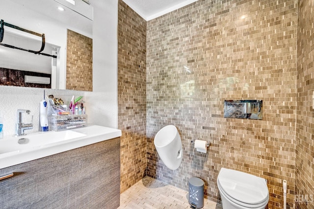 bathroom with tile patterned flooring, vanity, toilet, and tile walls