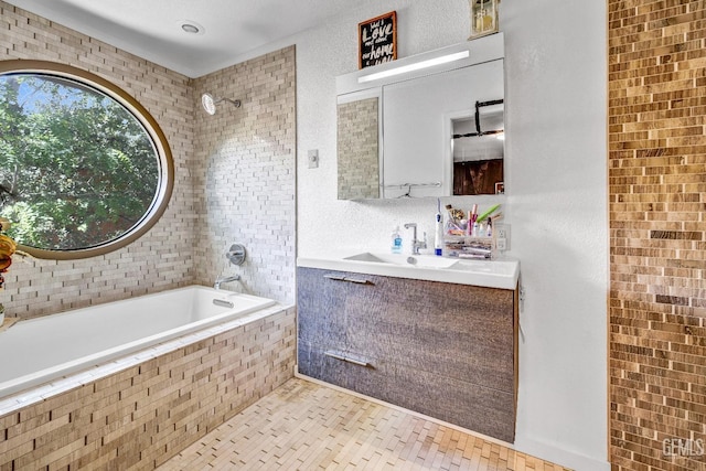 bathroom featuring tile patterned floors, tiled shower / bath combo, and vanity