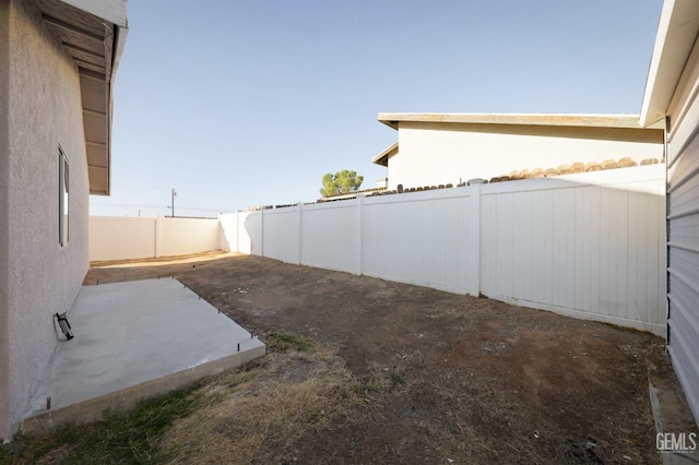 view of yard featuring a patio area and a fenced backyard