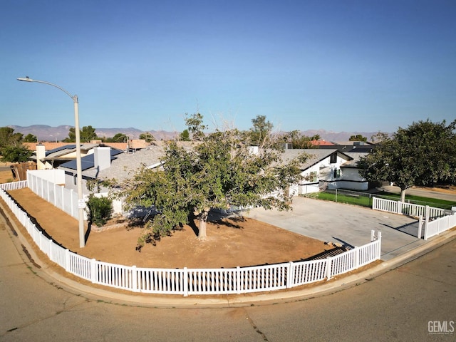 view of front facade with fence and a mountain view