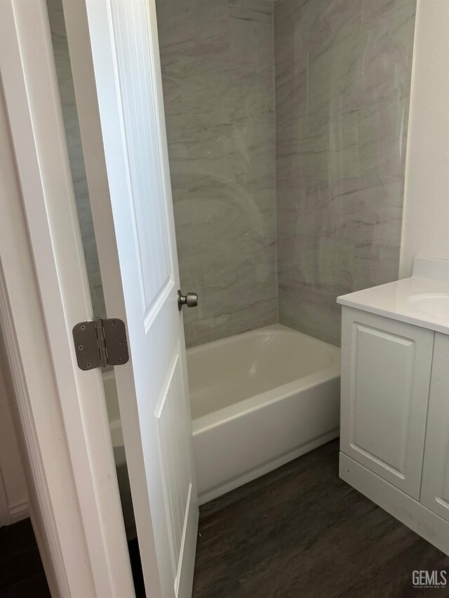 1012 Yosemite Dr, Bakersfield, CA 93308 - full bathroom with a tub, vanity, and wood finished floors