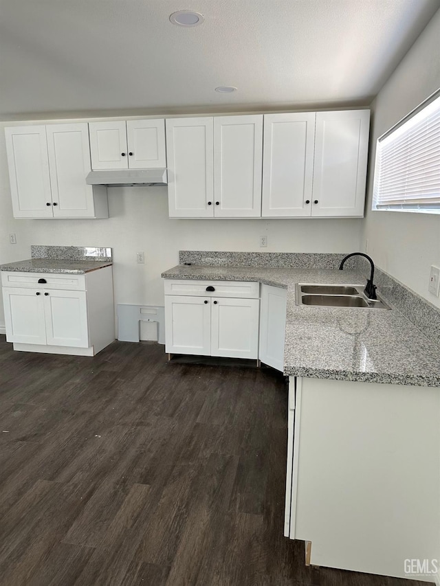1012 Yosemite Dr, Bakersfield, CA 93308 - kitchen featuring white cabinetry, light stone countertops, and dark wood-style flooring