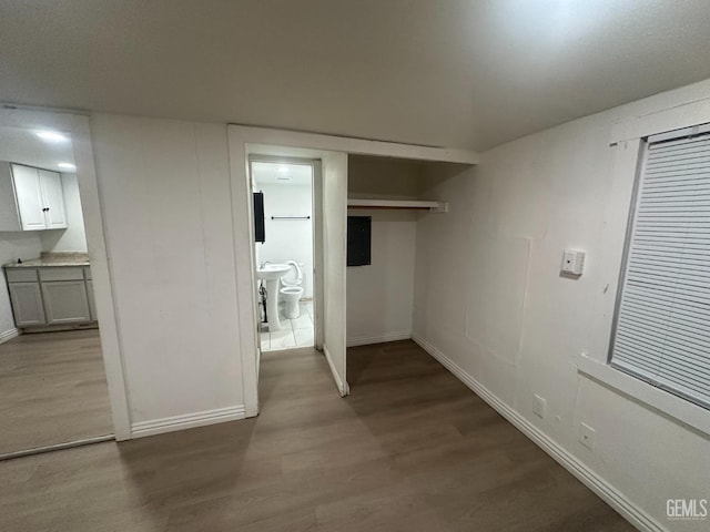 interior space featuring wood finished floors and baseboards