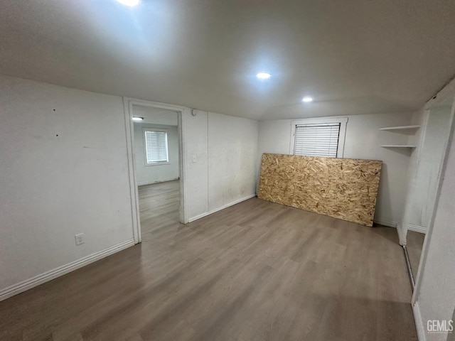 unfurnished room with baseboards and wood finished floors