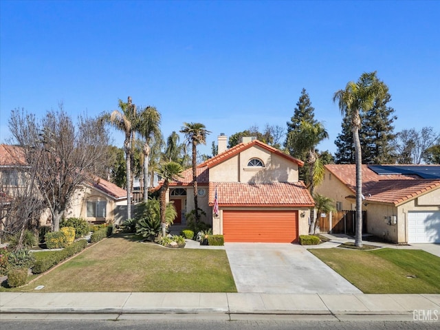 mediterranean / spanish house with a garage and a front yard