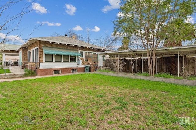 rear view of property with a yard and fence