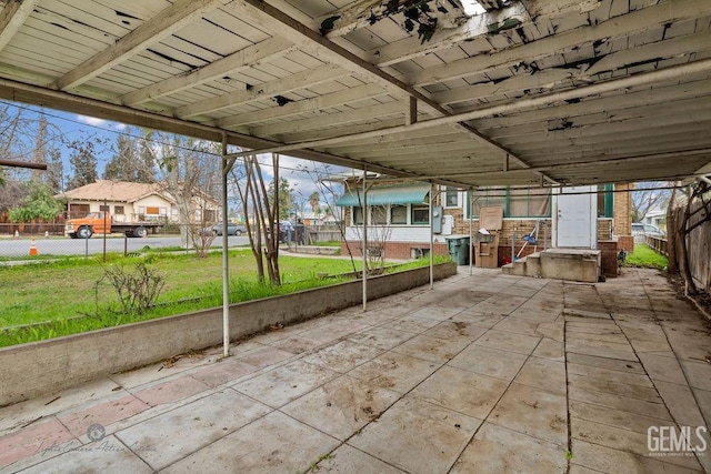 view of patio / terrace featuring a residential view, fence, and entry steps